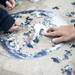 Volunteers Taylor Heilig and Samantha Whitkopf put together an Earth puzzle during PEACE Day on Sunday. P.E.A.C.E. stands for Promoting Ethnic And Cultural Equality. Daniel Brenner I AnnArbor.com